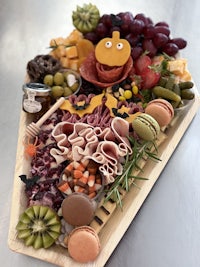 a wooden tray with a variety of meats and cheeses on it
