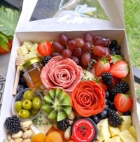 a box filled with fruit, nuts and cheese