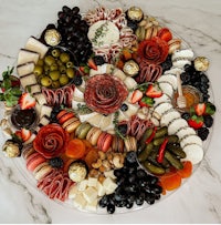 a cheese platter with a variety of meats and cheeses